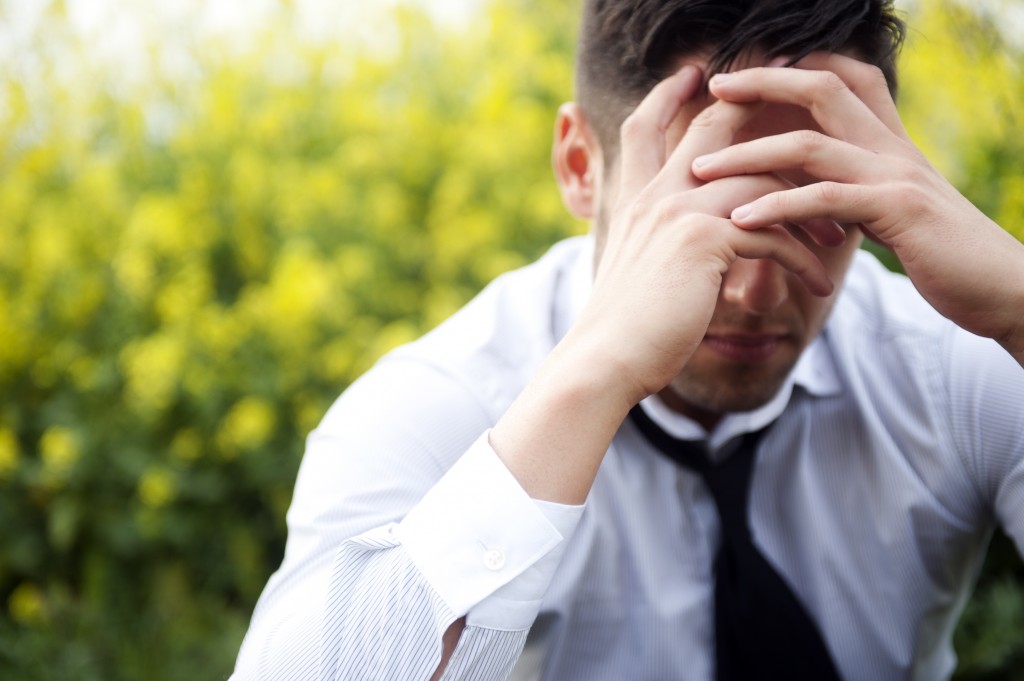 Frustrated man covering face