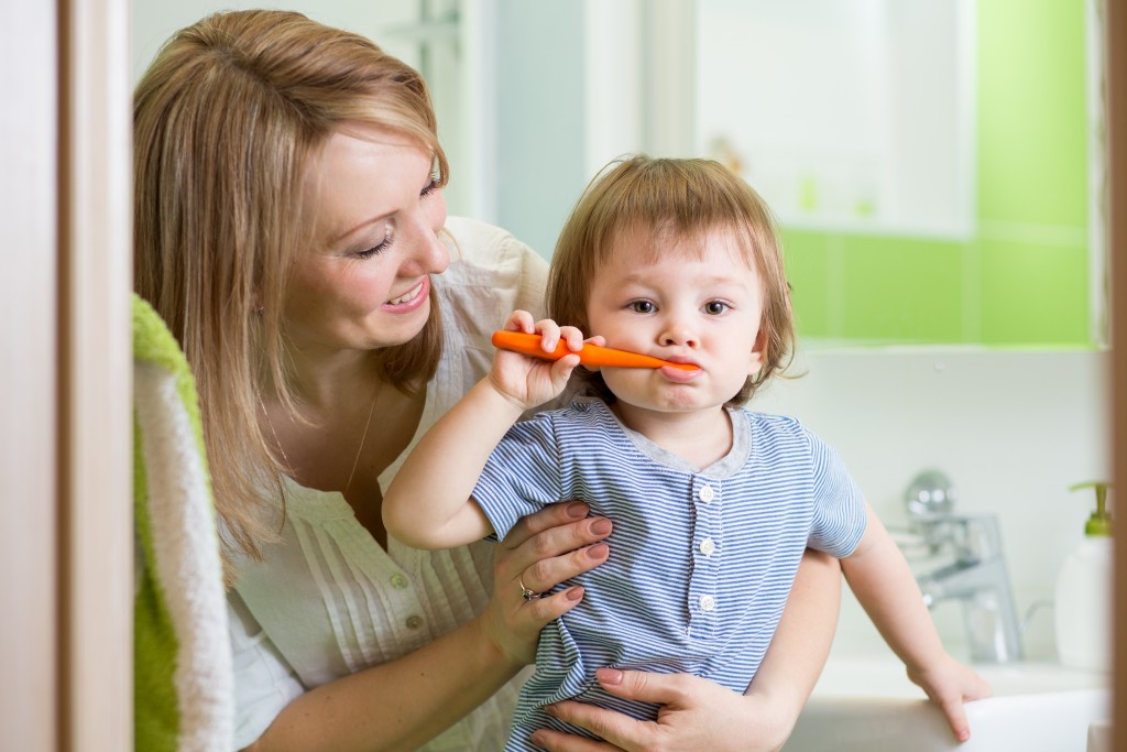 Mother and son brushing teeth learning routines