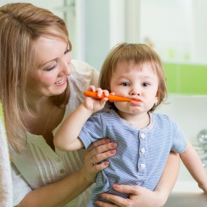 Mother and son brushing teeth learning routines